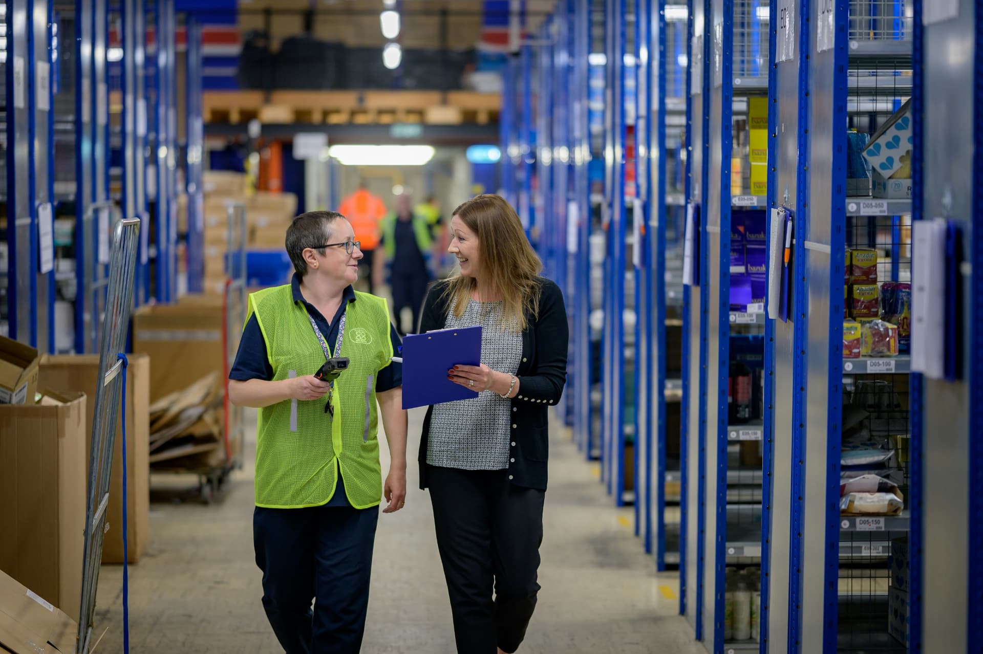 Warehouse colleagues walking a picking aisle in Amsterdam